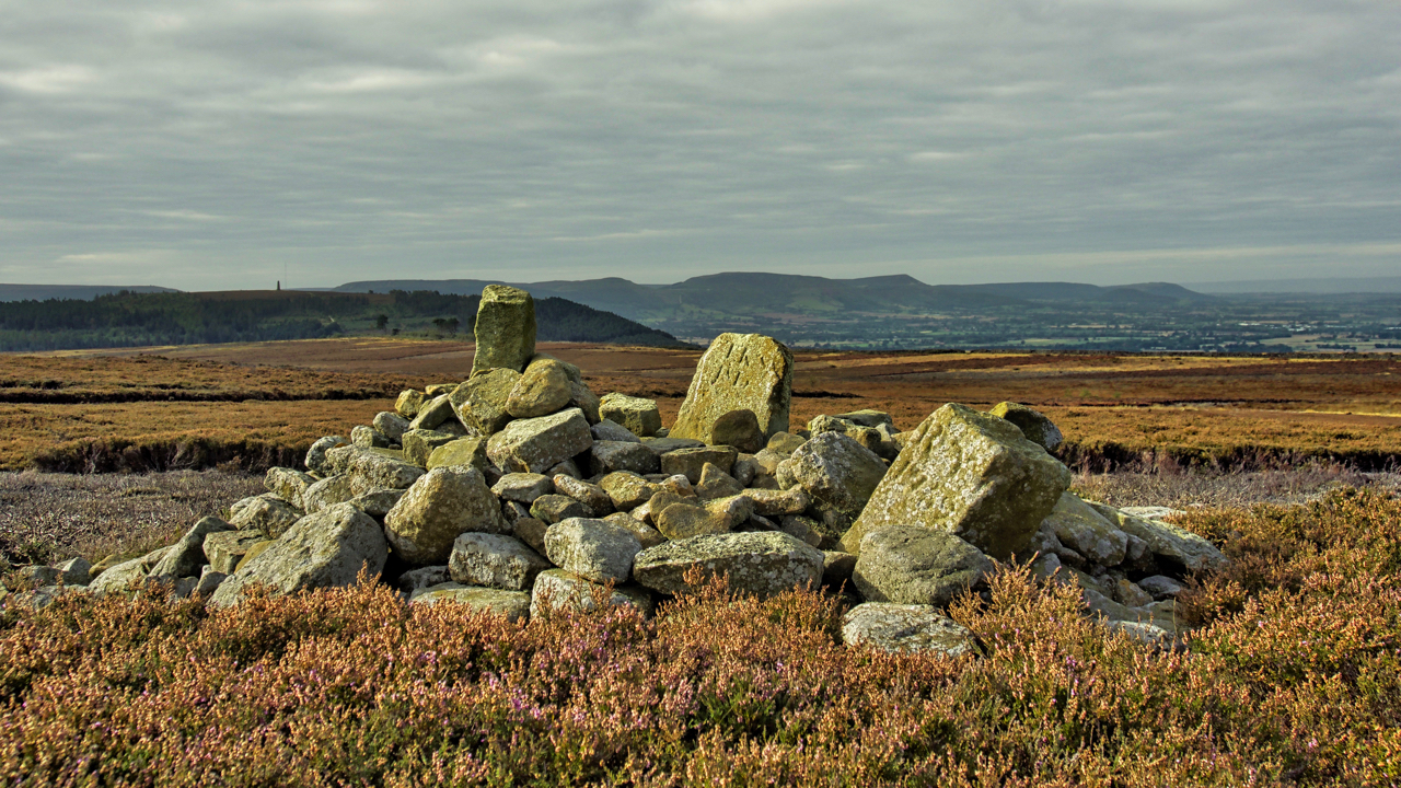Two boundary stones and a Bronze Age round cairn